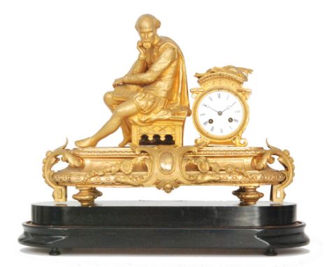 A late 19th Century French gilt metal figural mantle clock, the case with a seated scholar above scroll mounts and the white 