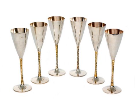 A set of six hallmarked silver champagne flutes with parcel gilt textured stems, height 22.5cm, total weight 38.5oz, London 1