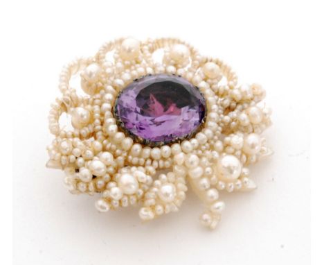 A 19th Century seed pearl and amethyst brooch modelled as a flower, cushion oval central amethyst within a pearl surround, le