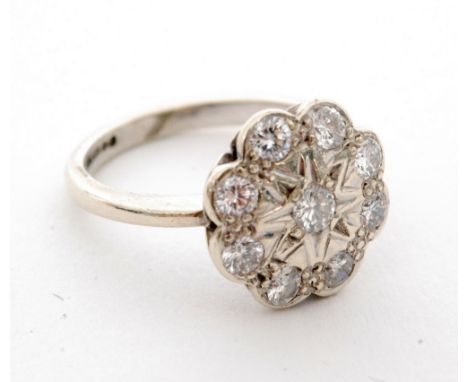 A 9ct hallmarked white gold diamond cluster ring, circular flat head detailed with nine brilliant cut diamonds in a daisy sty