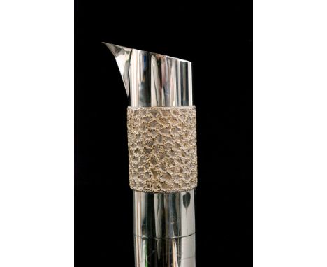 A hallmarked silver cylindrical water jug with central textured parcel gilt decoration, height 19cm, weight 16oz, London 1979