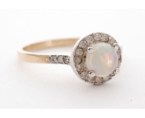 A 9ct hallmarked opal and diamond cluster ring, central claw set opal within sixteen stone diamond surround and diamond set s