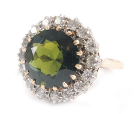 An 18ct green tourmaline and diamond cluster ring, central circular tourmaline within a sixteen stone diamond surround, ring 