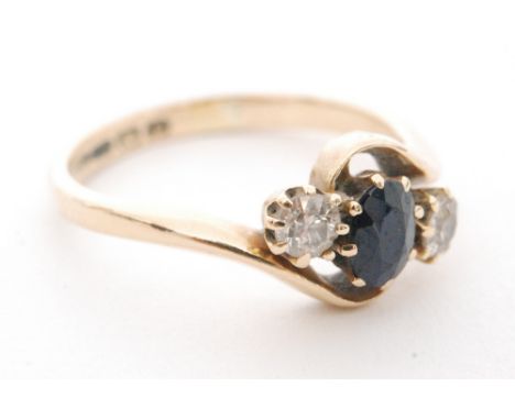 A mid 20th Century 18ct hallmarked sapphire and diamond three stone ring, central sapphire flanked by diamonds all to a sligh