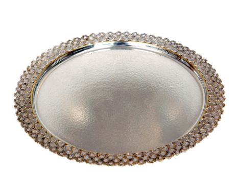 A hallmarked silver circular salver with planished body within stylised pierced textures parcel gilt border, diameter 30cm, w