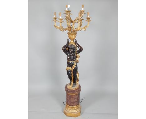 Electrolier cast in the form of a blackamoor, supporting a nine branch light above his head, raised on a column, 200cm h