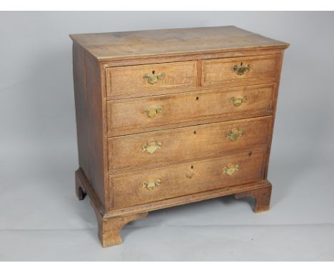 George III crossbanded oak chest fitted two short and three graduated long drawers on bracket feet 96 cms W