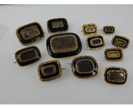 Twelve various gold, black enamel or black onyx and yellow metal rectangular mourning brooches