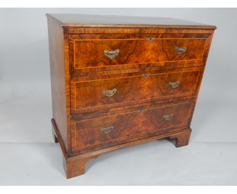 George II style walnut chest of drawers, the rectangular top above an arrangement of three drawers, on shaped bracket feet, 9