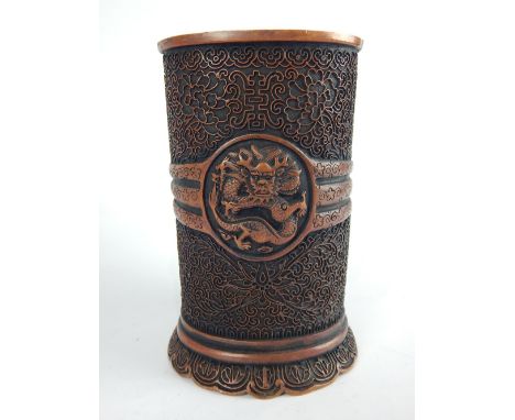 Chinese bronze brush pot, decorated with scrolling foliage and vignette of a dragon, C-scroll base, 16cm h