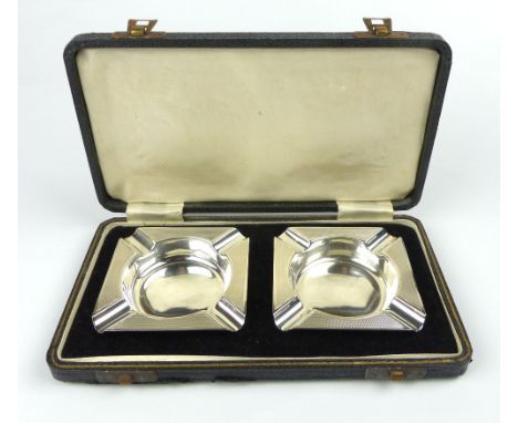 Pair of cased engine turned silver ashtrays