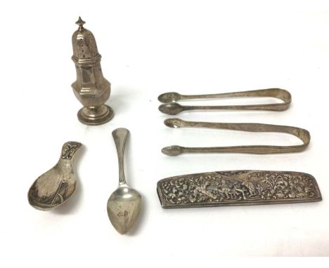 Group of silver, including continental caddy spoon and comb, a teaspoon, two sugar nips, and a caster