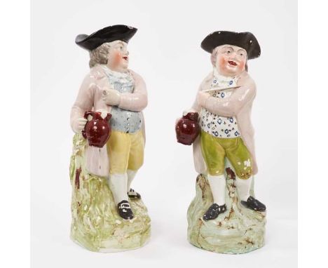 Two Pearlware-glazed 'Hearty Good Fellow' Toby jugs, early 19th century, similarly decorated, both with lilac jackets and red