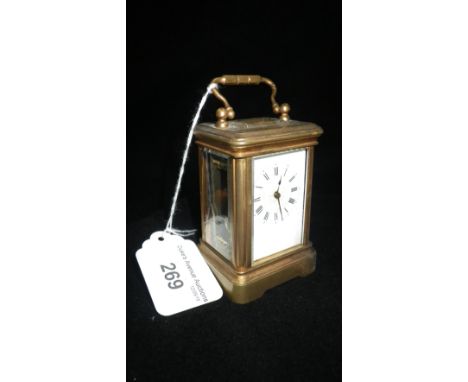 A late 19th/early 20th century miniature gilt brass carriage clock with bevelled glass panels