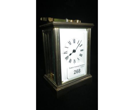 An Edwardian style brass carriage clock with bevelled glass panels