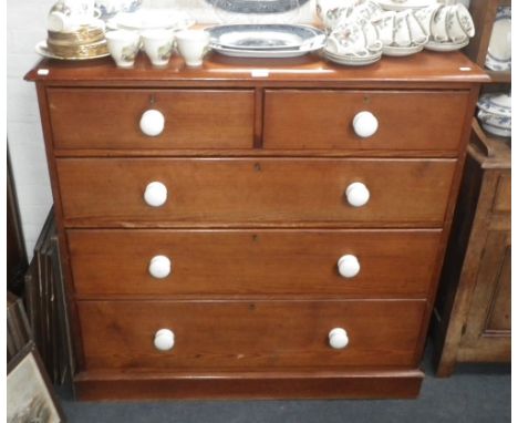 A Victorian pitch pine chest of drawers with white ceramic knobs. 45" wide 