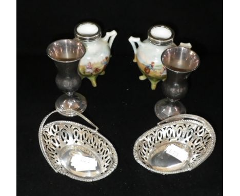 A pair of oval pierced silver sweetmeat dishes with swing handles, a pair of silver miniature vases and a pair of silver moun