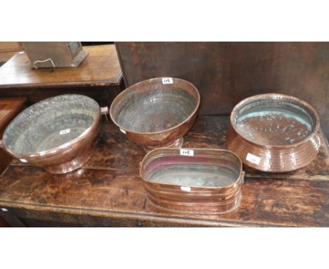 A collection of planished copper bowls and a similar planter 