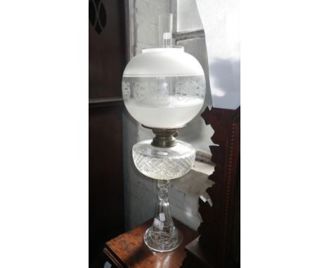 An oil lamp with cut-glass reservoir