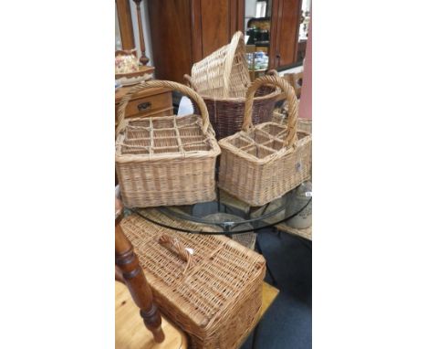 A wicker picnic hamper, a bottle carrier and similar wicker containers