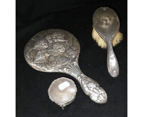 A Birmingham silver-backed dressing table mirror, decorated with portraits of cherubs, a similar engine-turned silver-backed 