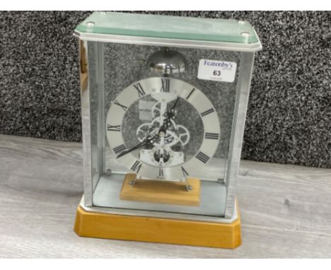 Skeleton mantle clock in glass display case