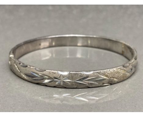A silver engraved bangle stamped 925 23.9g