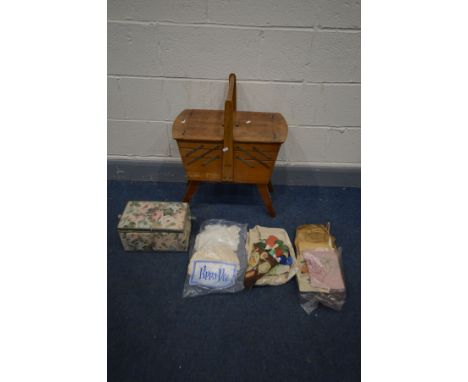 A VINTAGE WALNUT CANTILEVER SEWING BOX, a small sewing box, both containing sewing accessories, and sewing fabrics, etc