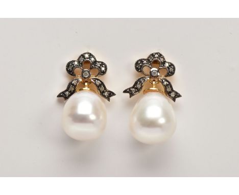 A PAIR OF YELLOW METAL, CULTURED PEARL AND DIAMOND DROP EARRINGS, each designed with bow shaped suspenders set with a single 