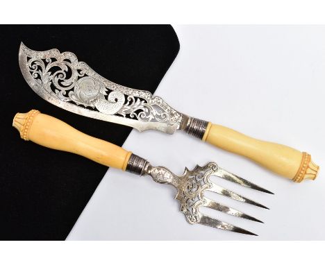 A VICTORIAN SILVER AND IVORY HANDLED FISH KNIFE AND FORK SERVERS, pierced detailed blades, with an engraved foliate design, f