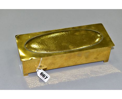A WMF BRASS AND WOOD CIGARETTE BOX, Circa 1910, the hinged lid has a planished, oval panel, the carcass is lightly planished,