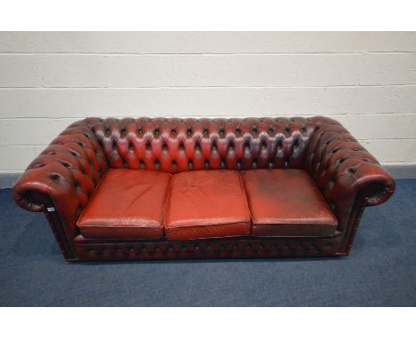 A BURGUNDY LEATHER CHESTERFIELD SOFA, Length 198cm (condition - cushions worn and cracking, but no rips)