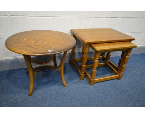 AN ERCOL GOLDEN DAWN CIRCULAR OCCASIONAL TABLE with a glass undershelf, diameter 60cm x height 48cm along with an oak nest of