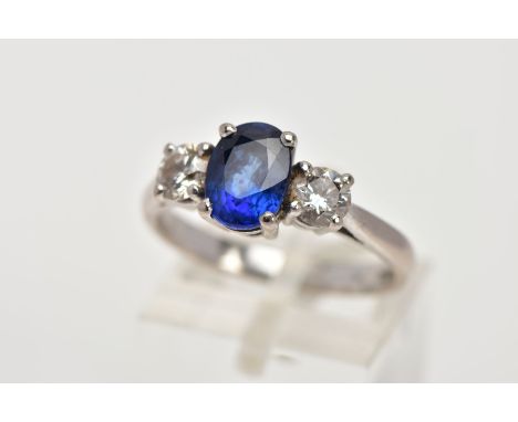 AN 18CT WHITE GOLD SAPPHIRE AND DIAMOND RING, designed with a four-claw set, oval cut blue sapphire, measuring approximately 