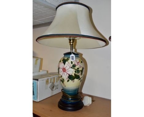 A MOORCROFT POTTERY TABLE LAMP IN THE HIBISCUS MOON PATTERN BY SIAN LEAPER, baluster shaped lamp base with original fabric sh