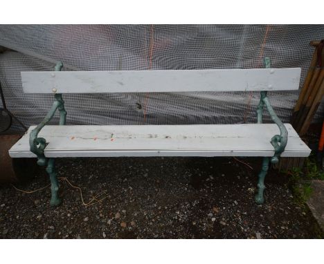 A HEAVY CAST IRON GARDEN BENCH, the ends in the form branches, later painted, length 180cm