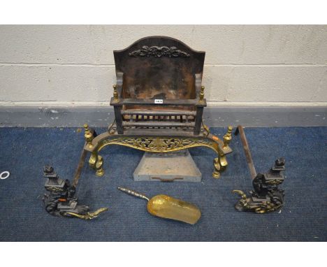 A CAST IRON AND BRASS FIRE GRATE with foliate brass apron and finials, width 63cm x depth 29cm x height 58cm, a pair of andir