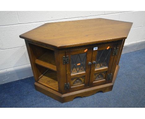 AN OAK OLD CHARM TV CABINET, double lead glazed doors enclosing a single shelf, width 103cm x depth 48cm x height 61cm