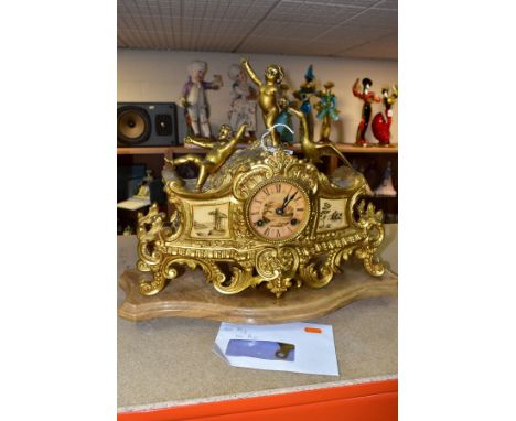 A LATE 19TH CENTURY FRENCH STYLE GILT METAL MANTLE CLOCK, the hand painted dial has a river landscape to the centre with Roma