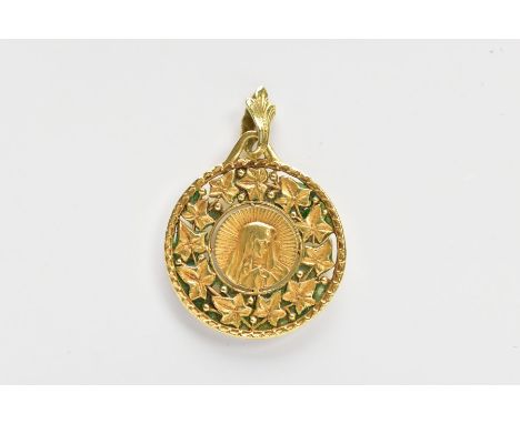 A YELLOW METAL PENDANT, of a circular form depicting the virgin Mary within a surround of vine leaves, engraved to the revers