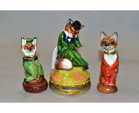A ROYALE STRATFORD FOX BONBONNIERE AND TWO SIMILAR SCENT BOTTLES, all three modelled as seated foxes dressed in hunting attir