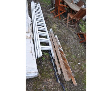 A VINTAGE WOODEN STEP LADDER height 141cm and a wooden triple extension ladder with eleven rungs to each 3m section