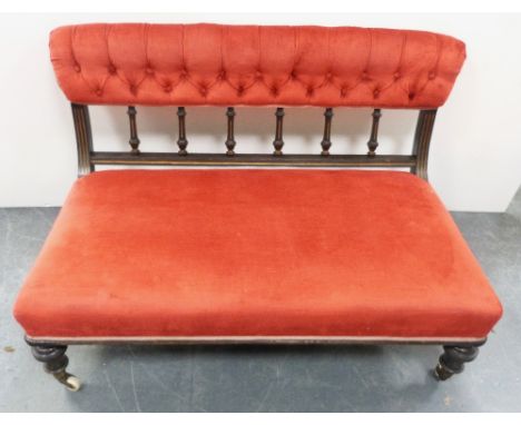 Late Victorian aesthetic ebonised boudoir sofa, upholstered in later red button-back Dralon, with spindle decoration, on cera