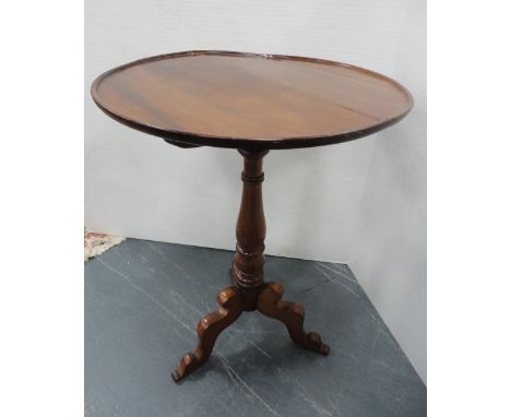 George III mahogany tripod table with snap-action saucer top, 75cm high and 56cm wide.CONDITION REPORT: Large deep crack to t