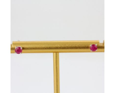 A pair of 9ct white gold ruby set stud earrings, dia. 0.4cm.