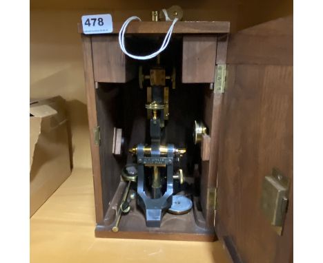 A mahogany cased antique microscope.