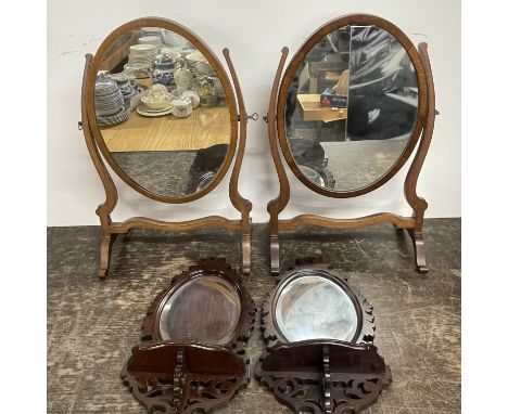 A group of two mahogany dressing table mirrors together with two wall brackets and a wooden table lamp.