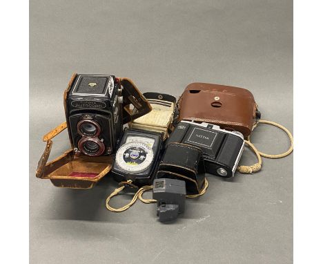 A Minal autocord twin lens reflex camera with a Nettar camera and two light metres.