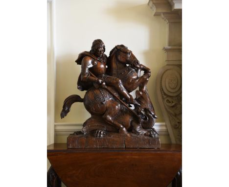 A LARGE CARVED OAK MODEL OF ST. GEORGE AND THE DRAGON PROBABLY EARLY/MID 19TH CENTURY, NORTH EUROPEAN  The armoured saint dep