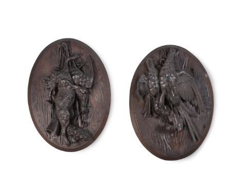 A PAIR OF BLACK FOREST CARVED HUNTING TROPHY PLAQUES LATE 19TH CENTURY With fox, wild game and riding crops and horneach 60cm